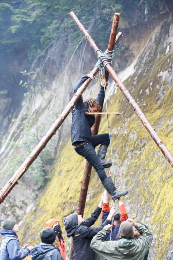 Activists at the Waterfall Camp lift a protester into a tripod structure, an obstruction that is used to block logging roads.