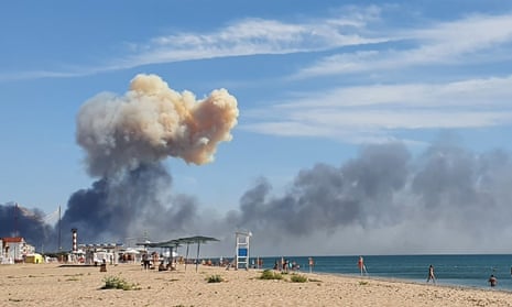Rising smoke can be seen from the beach at Saky, in Crimea, after explosions were heard on 9 August.
