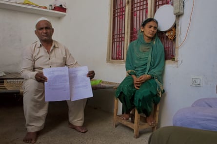 Irfan Ahmed, left, served with a notice that his house has been illegally built on government land