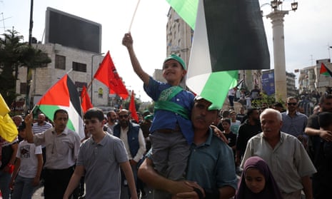 Protesters wave Palestinian flags during a demonstration in support of the Palestinian people in Ramallah, West Bank.