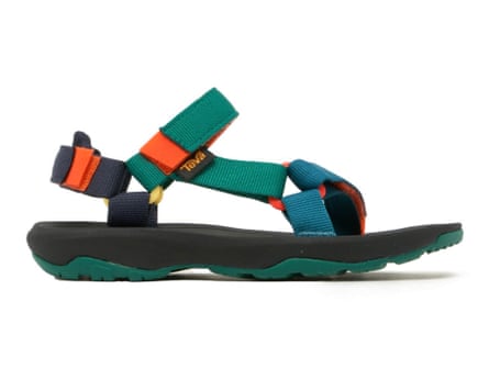 A side view of a Teva Hurricane XLT 2 Junior shoe in black green orange and teal. The shoe has a toe and ankle strap.