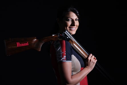 A portrait of a woman with a gun over her shoulder
