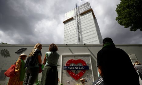 People attending a commemoration to mark the third anniversary of the Grenfell Tower fire in 2020.