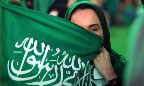 A female Saudi Arabia fan watches the Poland match