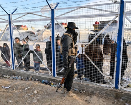 A member of the Syrian security forces at the entrance of the al-Hawl camp in January.