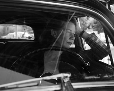 A woman looking out of a car window.