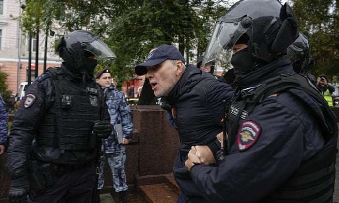 Another protester being detained in Moscow yesterday