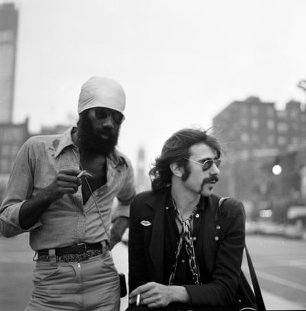 men on city street, both in sunglasses