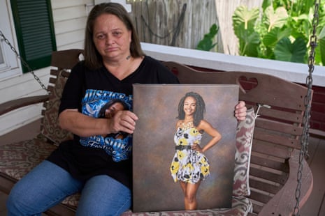 a mom holding a photo of her late daughter