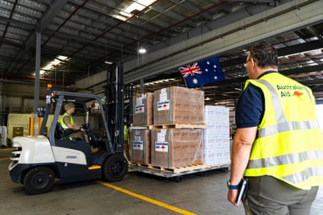 RAAF and Australian Aid workers prepare an aid shipment at RAAF Base Amberley.