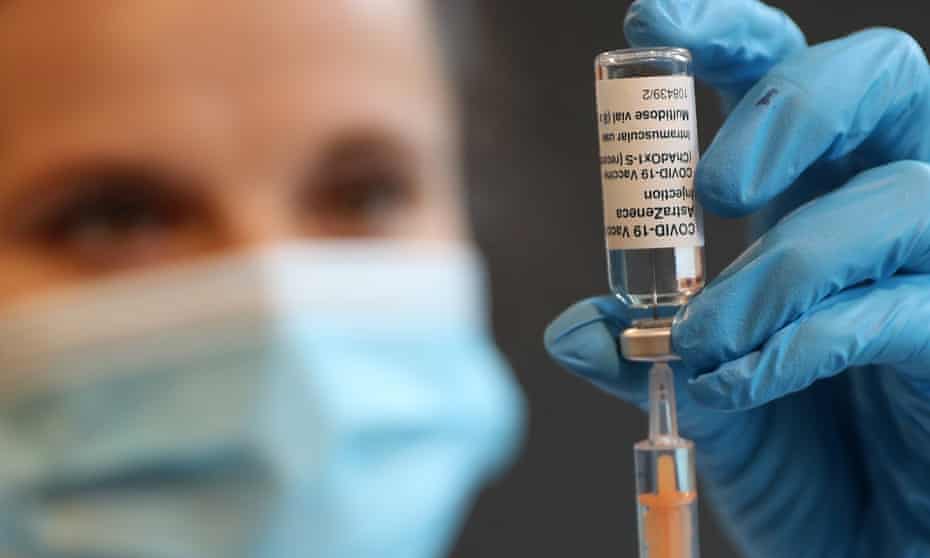 A pharmacist prepares a shot of the Oxford/AstraZeneca vaccine at Kingston University in London