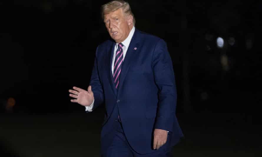 Trump walks from Marine One to the White House on Friday night.