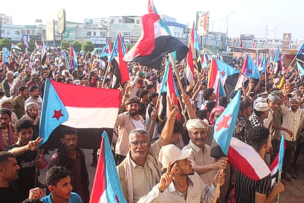 Yemeni supporters of the UAE-backed Southern Transitional Council wave the old South Yemen flag as they rally in the port city of Aden
