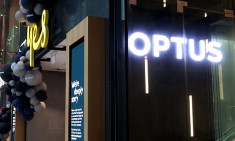 Front of Optus store with sign saying 'We're deeply sorry'