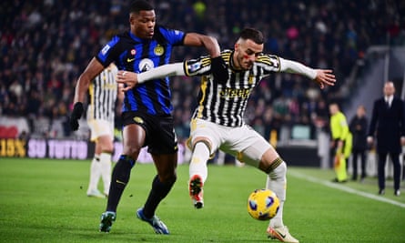 Internazionale’s Denzel Dumfries challenges Juventus’ Filip Kostic for the ball.
