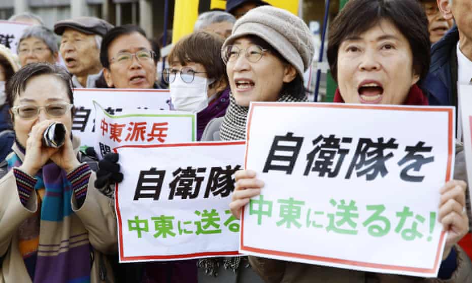Protesters in Tokyo with placards that read: “Do not send Japan’s self-defence forces to the Middle East.”