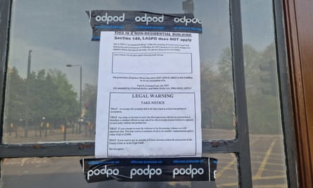 A piece of paper with large writing saying 'This it a residential building' and 'Legal warning – take notice'