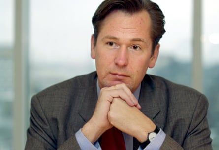 Döpfner looking off-camera with his hands folded