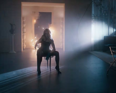 Madonna sitting on a chair in a large room