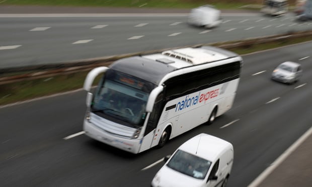 A National Express coach drives along the M6