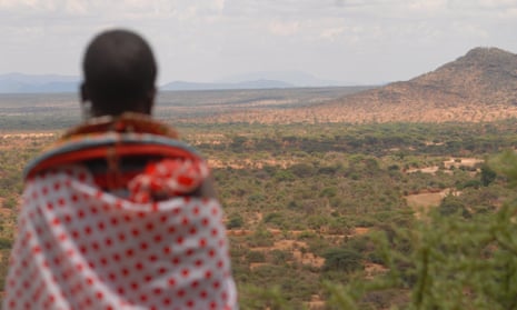 A woman gazes across the vast rangelands of northern Kenya that have been without rain for more than three years.