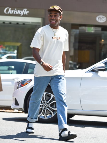 Tyler the Creator in white socks and sandals.