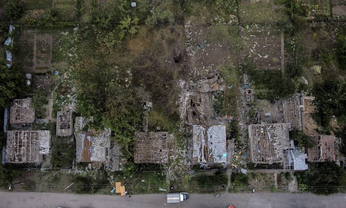 A crater from a Russian rocket attack Friday night is seen next to damaged homes in Kramatorsk, Donetsk region, eastern Ukraine. The strike killed three people and wounded 13, according to the mayor.