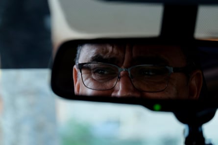 close up of a man’s eyes reflected in a rearview mirror