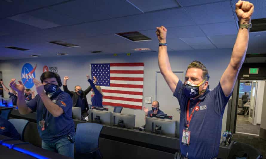 Members of Nasa’s Perseverance rover team react in mission control after receiving confirmation the spacecraft successfully touched down on Mars.