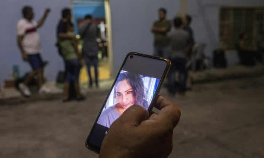 A relative of the murdered video journalist Sheila Johana García Olivera shows her photo on a cellphone outside her family’s home where her wake takes place in Minatitlán, Veracruz state, Mexico, last week.