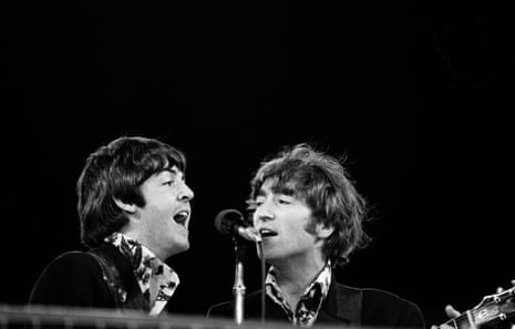 Head and shoulders image of McCartney and Lennon singing into a microphone