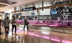 Shoppers walk past the Butcher Club