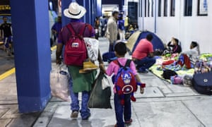 A Venezuelan and his son arrive in Tumbes, Peru, to claim refugee status.