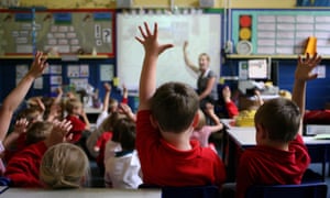 teacher in classroom full of children