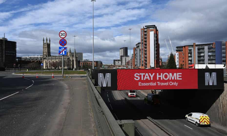 A road sign in Manchester alerts motorists to stay home