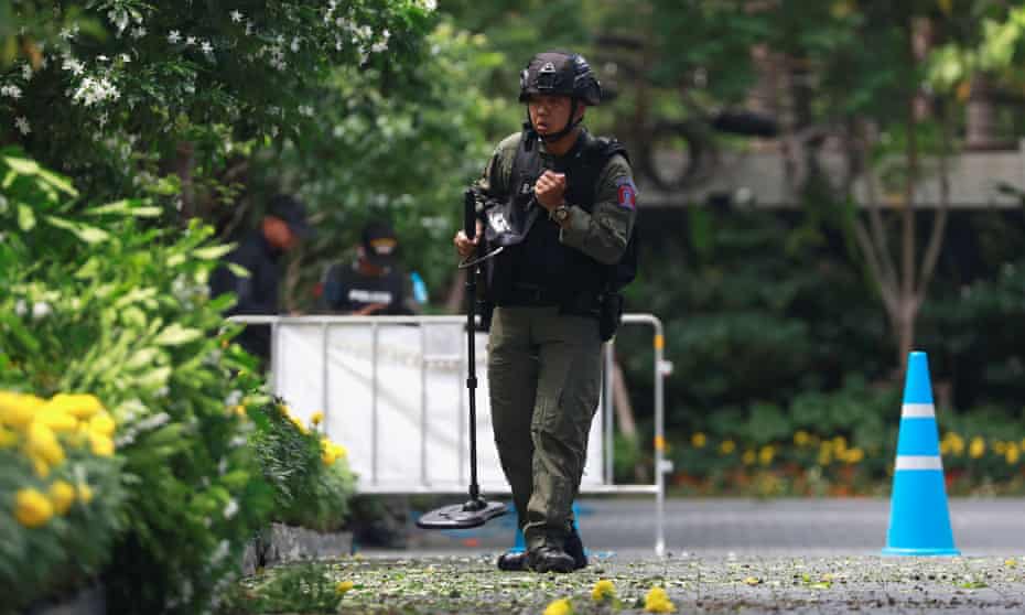 Bomb disposal officers at the scene of a small explosion in Bangkok. Blasts were reported at two other locations.
