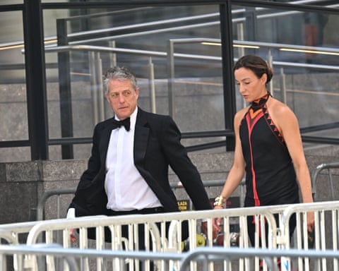 a man in a tuxedo and a woman in a black dress