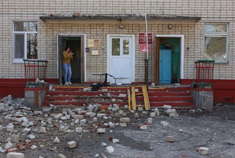 A woman stands at the entrance to a kindergarten building in Belgorod hit by shelling, in what local authorities have called a Ukrainian military strike, on Wednesday.