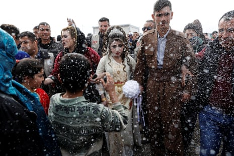 Hussain Zeeno Zannun, 26, and Chahad, 16, Iraqi newlyweds who fled Mosul, are showered in foam during their wedding party at Khazer camp in Iraq