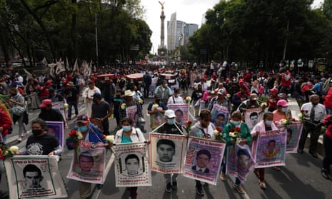 Relatives and classmates of the missing 43 Ayotzinapa college students march in Mexico City, on 26 September 2022, marking the anniversary of their disappearance. 