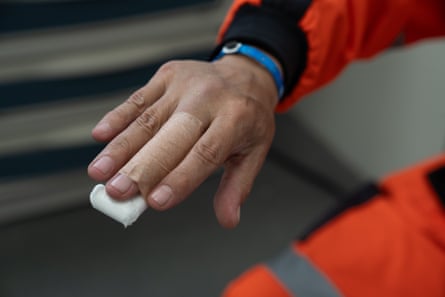 Inside the hospital, a member of the race support staff has his finger X-rayed and bandaged after an accident during the race preparations.