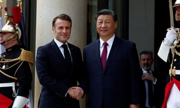 French president Macron greets China's President Xi  as he arrives for a meeting at the Élysée Palace in Paris.