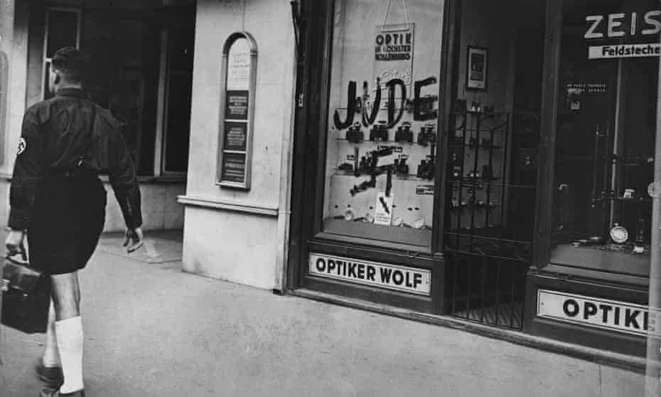 A Jewish-owned optician’s shop in Austria marked by Nazis with the word ‘Jew’ and a swastika.