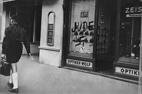 A Jewish-owned optician’s shop in Austria marked by the Nazis with the word ‘Jew’ and a swastika.