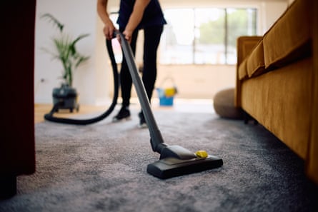 Closeup of female utilizing vacuum cleaner