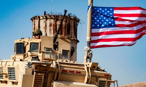 FILES-SYRIA-CONFLICT-TURKEY-KURDS-military(FILES) In this file photo taken on October 06, 2019 a US soldier sits atop an armoured vehicle during a demonstration by Syrian Kurds against Turkish threats next to a base for the US-led international coalition on the outskirts of Ras al-Ain town in Syria’s Hasakeh province near the Turkish border. - The Pentagon said Sunday President Donald Trump had ordered the withdrawal of up to 1,000 troops from northern Syria -- almost the entire ground force in the war-torn country -- amid an intensifying Turkish assault on Kurdish forces. (Photo by Delil SOULEIMAN / AFP) (Photo by DELIL SOULEIMAN/AFP via Getty Images)