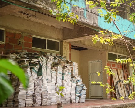 Large piles of discarded books next to the old Raizal university building