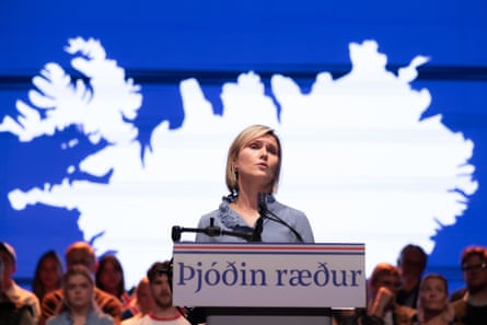 Reykjavík, Iceland, Prime Minister Kristrún Frostadóttir speaks at a podium reading “The nation decides” at Austurbæjarbíó, with people on stage behind her, 26 August 2026.