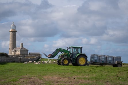 A tractor pulls water storage containers.