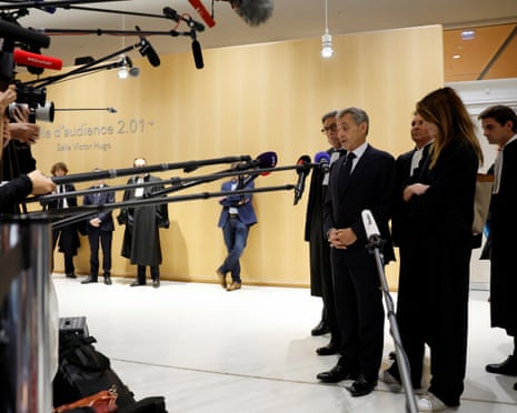 Former French President Nicolas Sarkozy talks to journalists, next to his wife Carla-Bruni Sarkozy and his lawyers, after the verdict in his trial with other defendants on charges of corruption and illegal financing of an election campaign related to alleged Libyan funding of his successful 2007 presidential bid, at the courthouse in Paris, France.